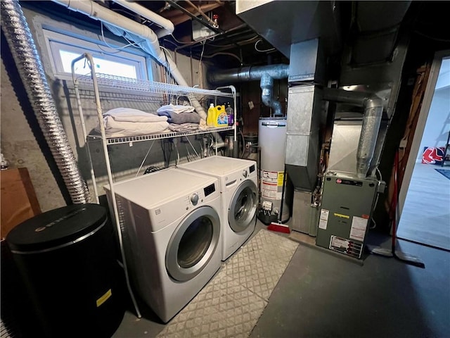 washroom with heating unit, water heater, and washer and clothes dryer