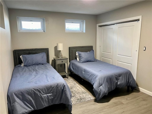 bedroom featuring hardwood / wood-style floors and a closet