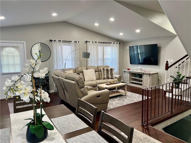 living room featuring dark hardwood / wood-style flooring and vaulted ceiling