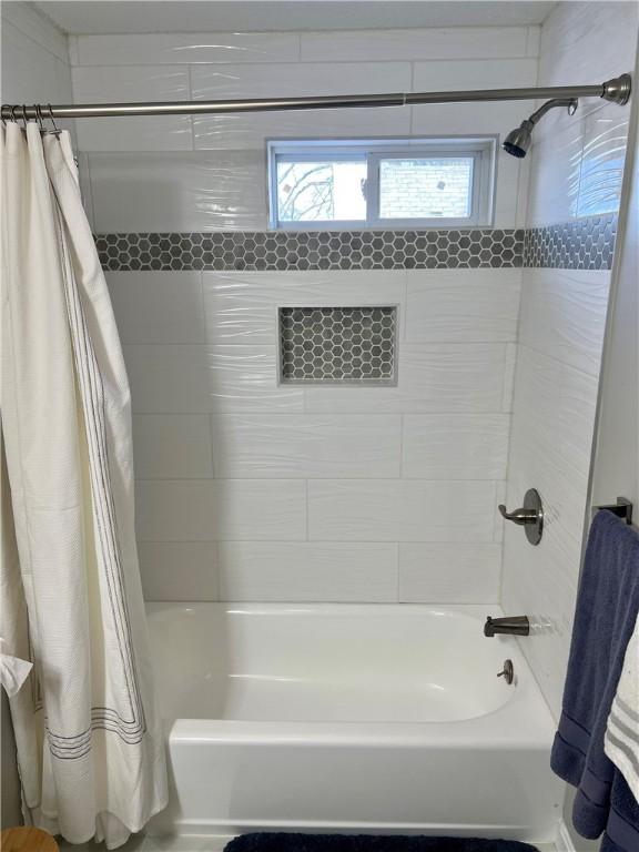 bathroom featuring shower / bath combination with curtain