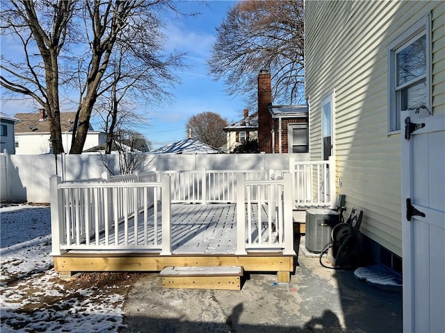 snow covered deck with central air condition unit