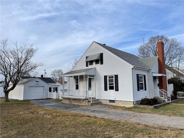 view of front facade with a garage, an outdoor structure, and a front lawn