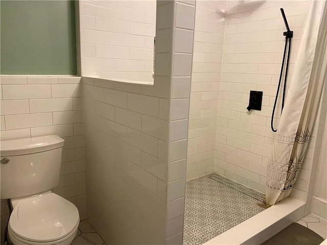 bathroom featuring toilet, tile walls, and a shower with shower curtain