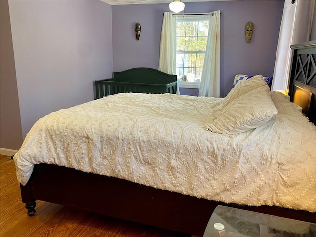 bedroom with hardwood / wood-style floors