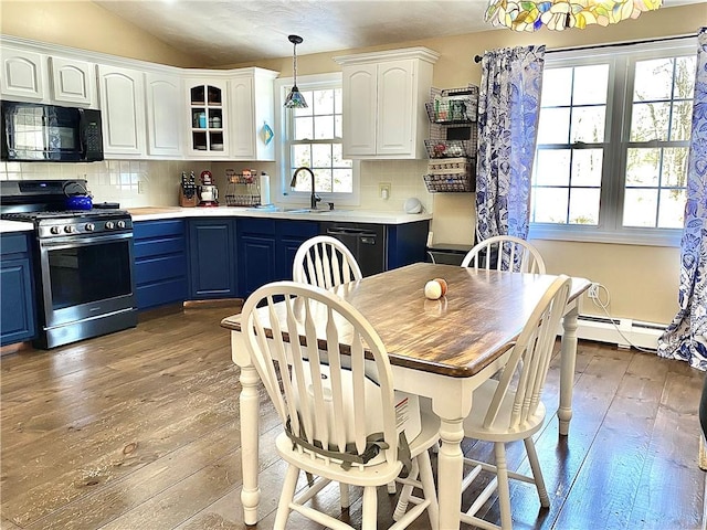 kitchen featuring blue cabinetry, decorative backsplash, pendant lighting, and black appliances