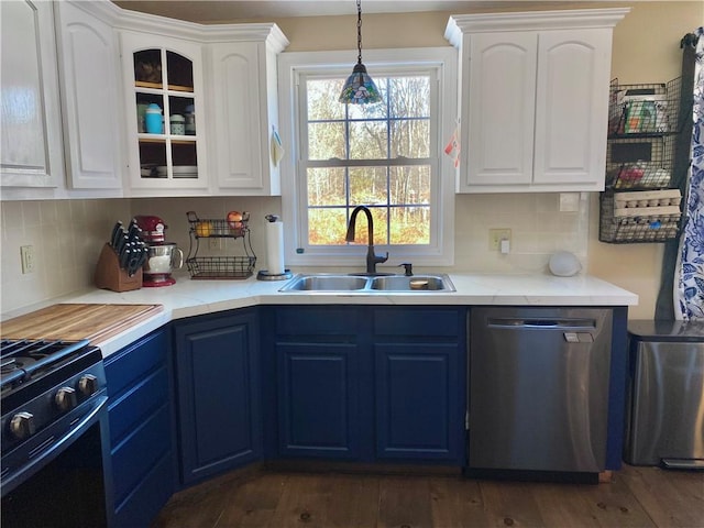 kitchen with stainless steel dishwasher, white cabinetry, sink, and tasteful backsplash