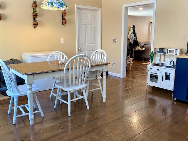 dining room featuring dark hardwood / wood-style floors and sink