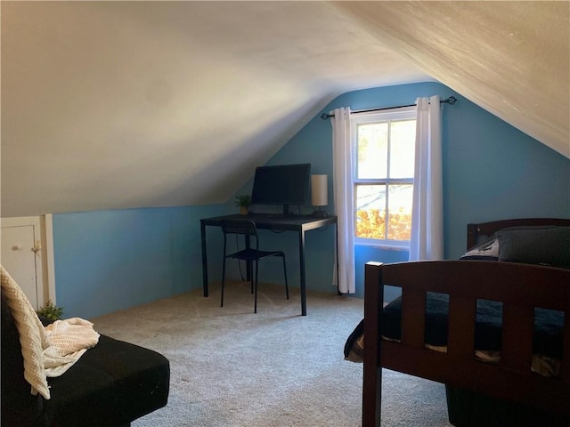 carpeted bedroom featuring lofted ceiling