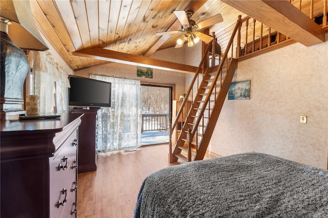 bedroom with access to outside, lofted ceiling with beams, ceiling fan, wood-type flooring, and wood ceiling