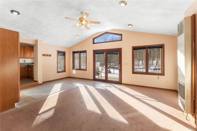 carpeted empty room featuring ceiling fan and vaulted ceiling