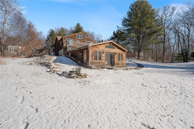 view of snow covered rear of property