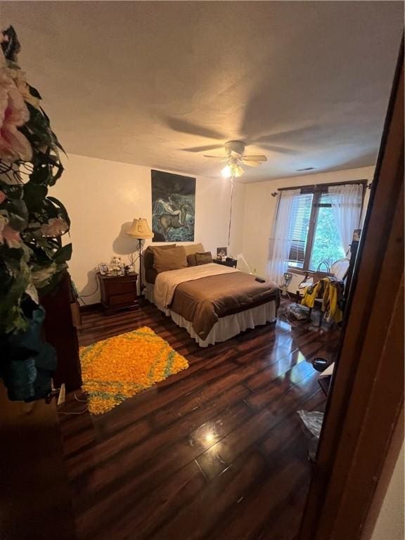 bedroom with ceiling fan and hardwood / wood-style flooring