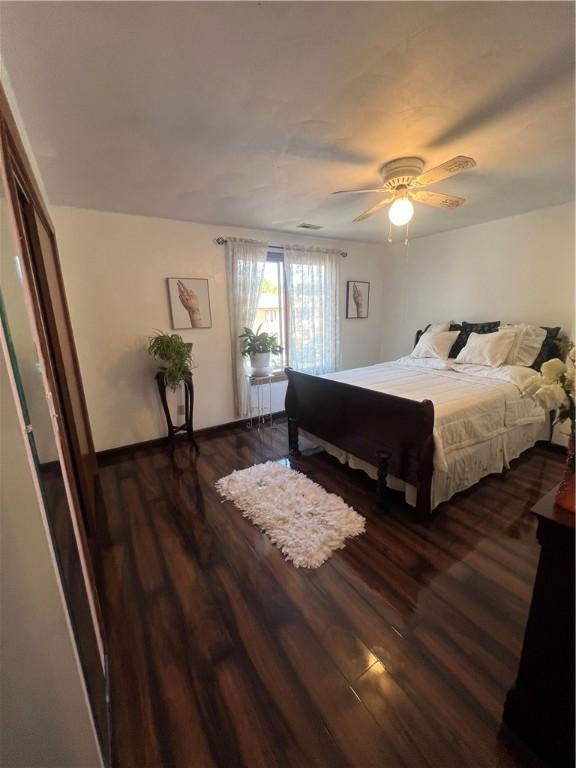 bedroom featuring ceiling fan, dark hardwood / wood-style flooring, and radiator heating unit