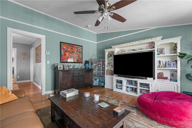 living room with hardwood / wood-style flooring, ceiling fan, ornamental molding, and vaulted ceiling