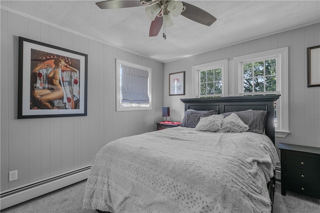 bedroom with a textured ceiling, ceiling fan, baseboard heating, and light carpet