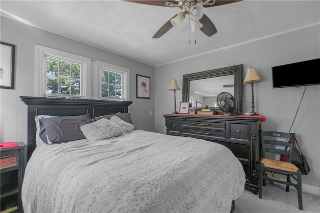 carpeted bedroom featuring a textured ceiling, ceiling fan, and crown molding