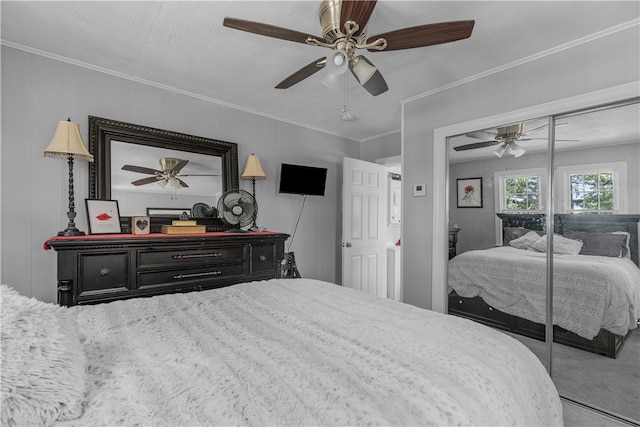 bedroom with a closet, ceiling fan, crown molding, and carpet