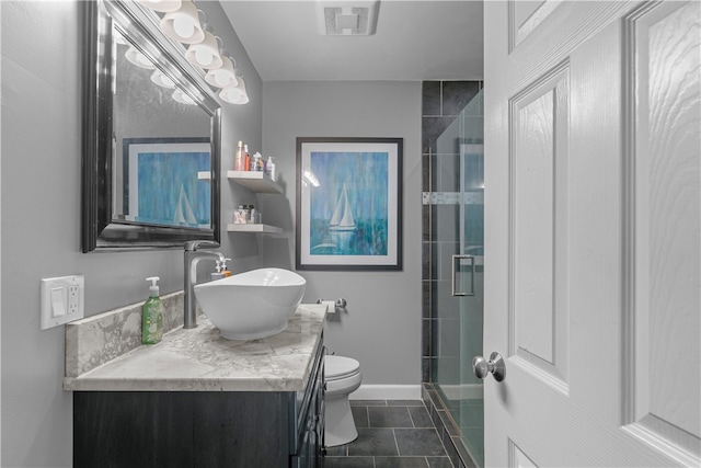 bathroom featuring tile patterned floors, vanity, toilet, and walk in shower