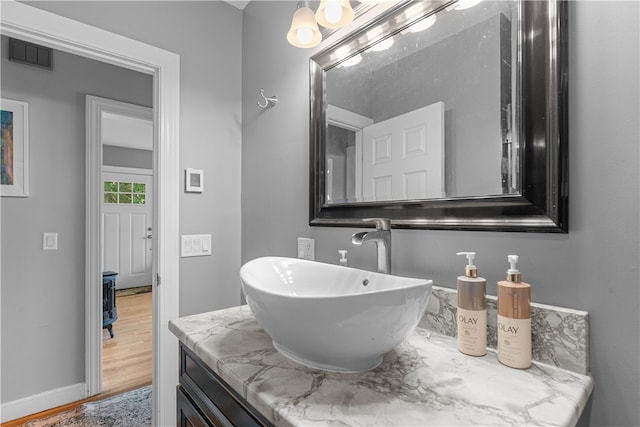 bathroom with vanity and wood-type flooring