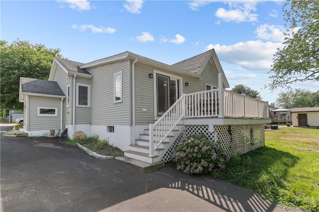 view of side of property with a wooden deck