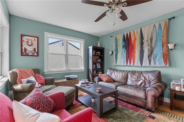 living room featuring ceiling fan and hardwood / wood-style flooring