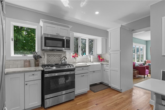 kitchen with plenty of natural light, sink, and appliances with stainless steel finishes