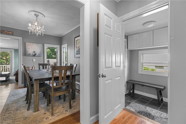 dining area with plenty of natural light, wood-type flooring, and ornamental molding