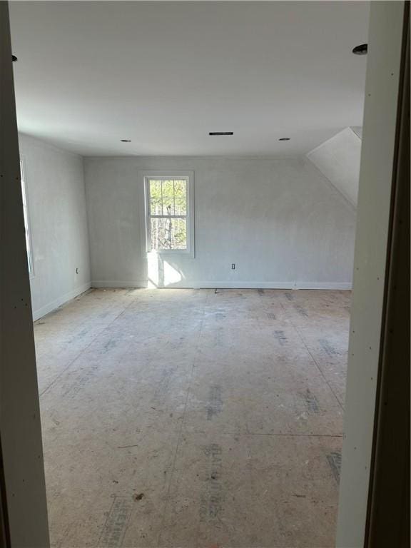 empty room with lofted ceiling