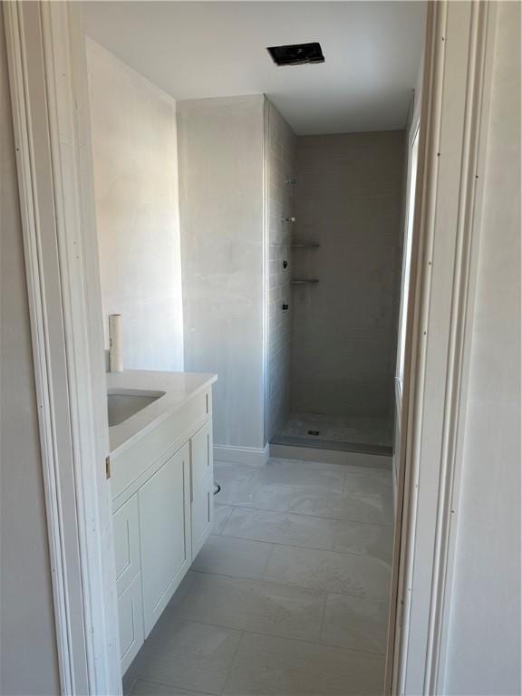 bathroom with a shower and vanity