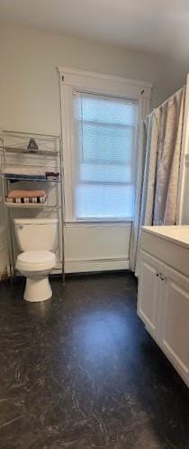 bathroom featuring vanity, baseboard heating, and toilet