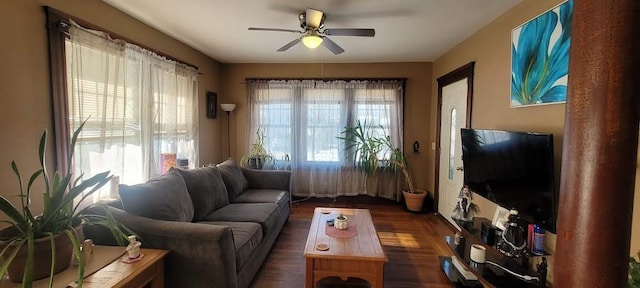 living room with dark wood-type flooring and ceiling fan