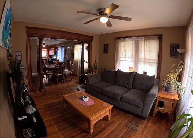 living room with dark hardwood / wood-style flooring and ceiling fan