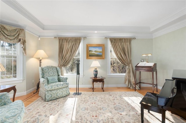 sitting room featuring ornamental molding and light hardwood / wood-style floors