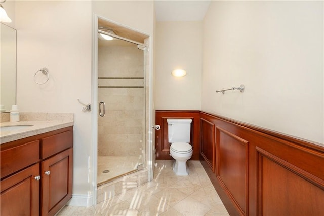 bathroom featuring vanity, an enclosed shower, and toilet