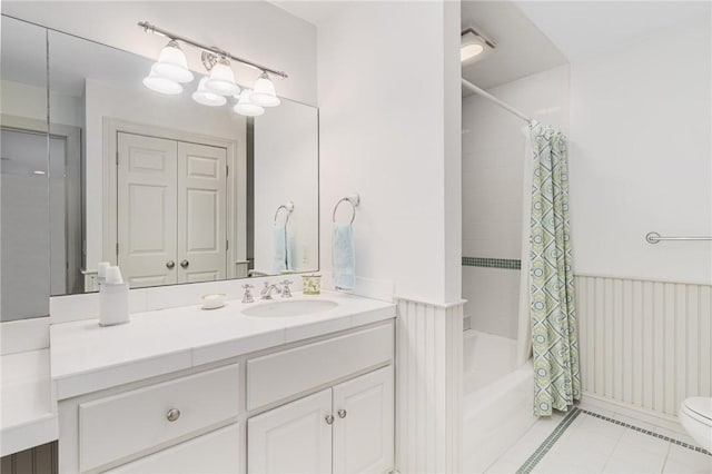 full bathroom featuring tile patterned flooring, vanity, shower / tub combo with curtain, and toilet