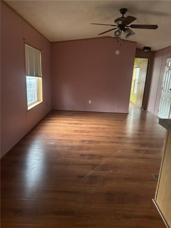 empty room with ceiling fan and light hardwood / wood-style flooring