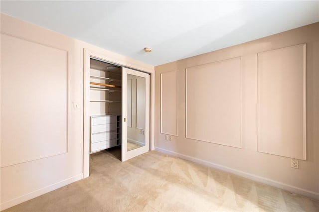 unfurnished bedroom with light colored carpet