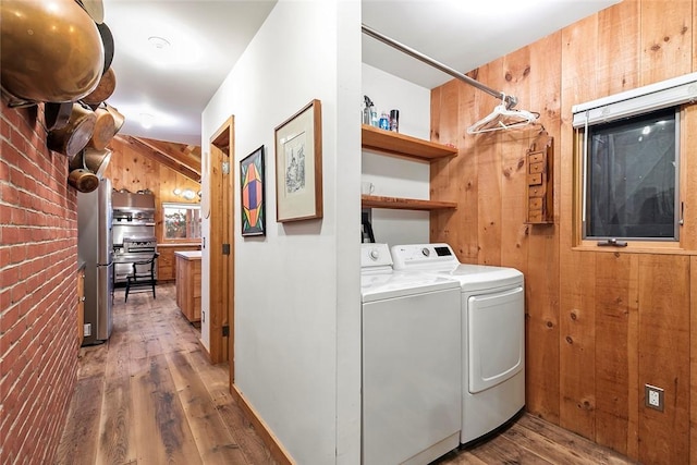 1635 Isabella Beach Rd, Southold, NY 06390 - washroom featuring washing machine and clothes dryer, wood walls, and wood finished floors
