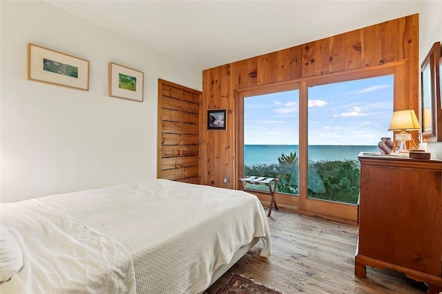1635 Isabella Beach Rd, Southold, NY 06390 - bedroom featuring light wood-type flooring and a water view