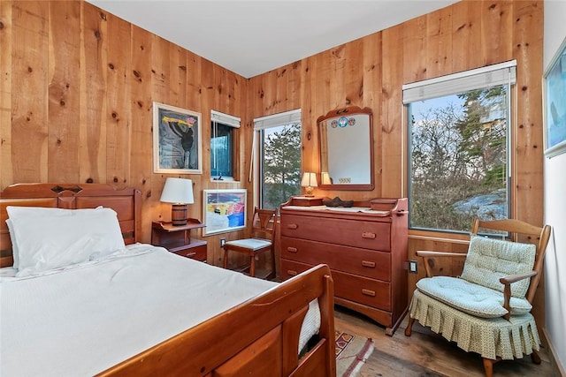 1635 Isabella Beach Rd, Southold, NY 06390 - bedroom featuring wood walls, wood finished floors, and multiple windows