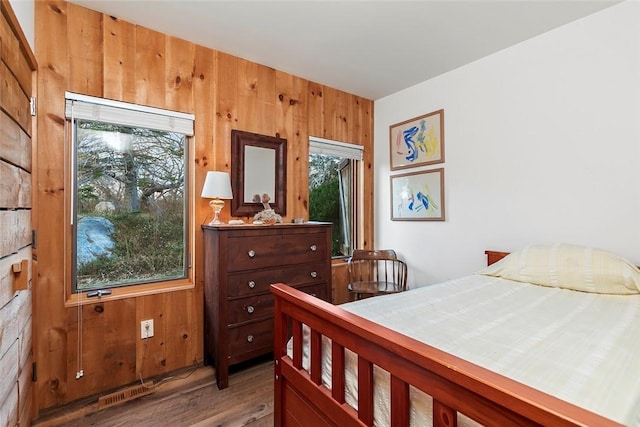 1635 Isabella Beach Rd, Southold, NY 06390 - bedroom with wooden walls and wood finished floors