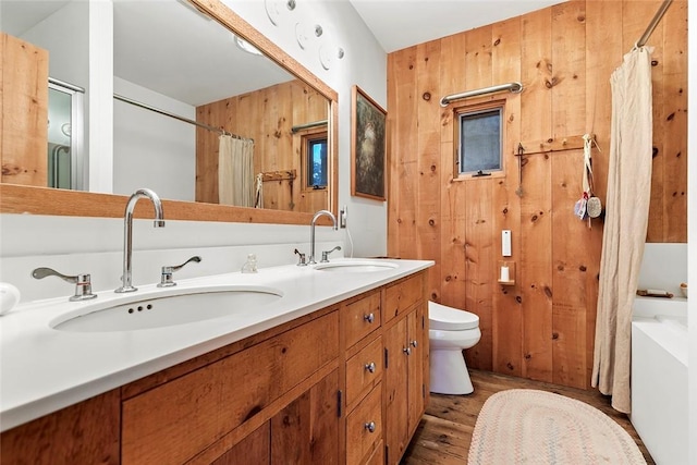 1635 Isabella Beach Rd, Southold, NY 06390 - full bath with wood finished floors, double vanity, and toilet