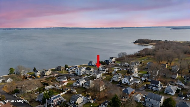 aerial view at dusk with a water view