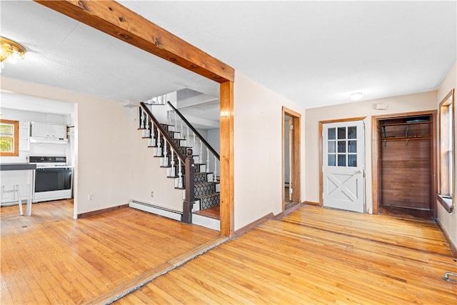 entryway featuring baseboard heating and light hardwood / wood-style flooring