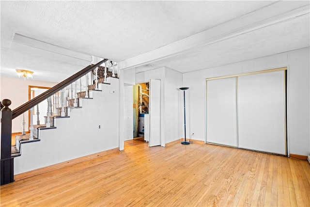 basement with wood-type flooring and a textured ceiling