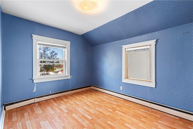 additional living space featuring hardwood / wood-style flooring and lofted ceiling