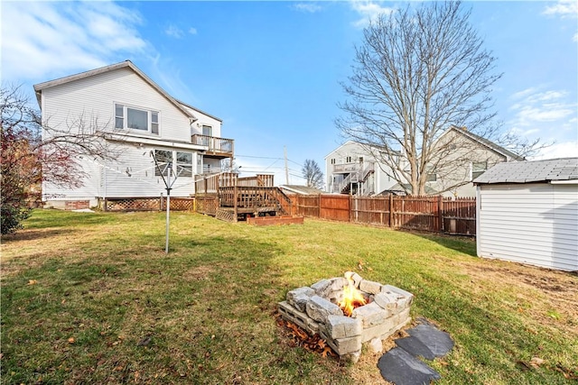 view of yard featuring a fire pit and a wooden deck