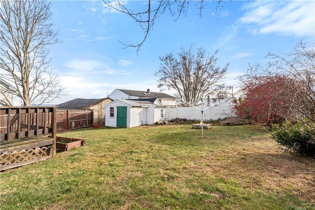 view of yard with a deck and a storage unit