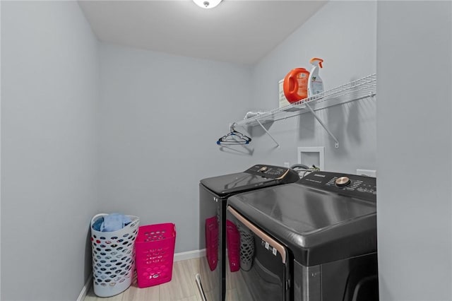 laundry room featuring washer and dryer and wood-type flooring