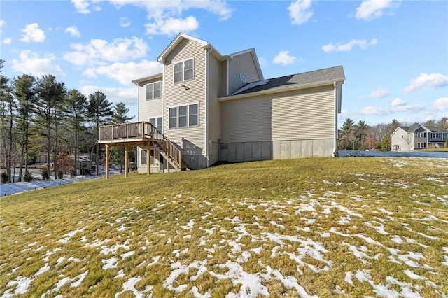 rear view of house with a deck and a lawn